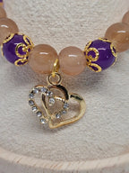Bracelet Étreinte Dorée - détail charm double cœur